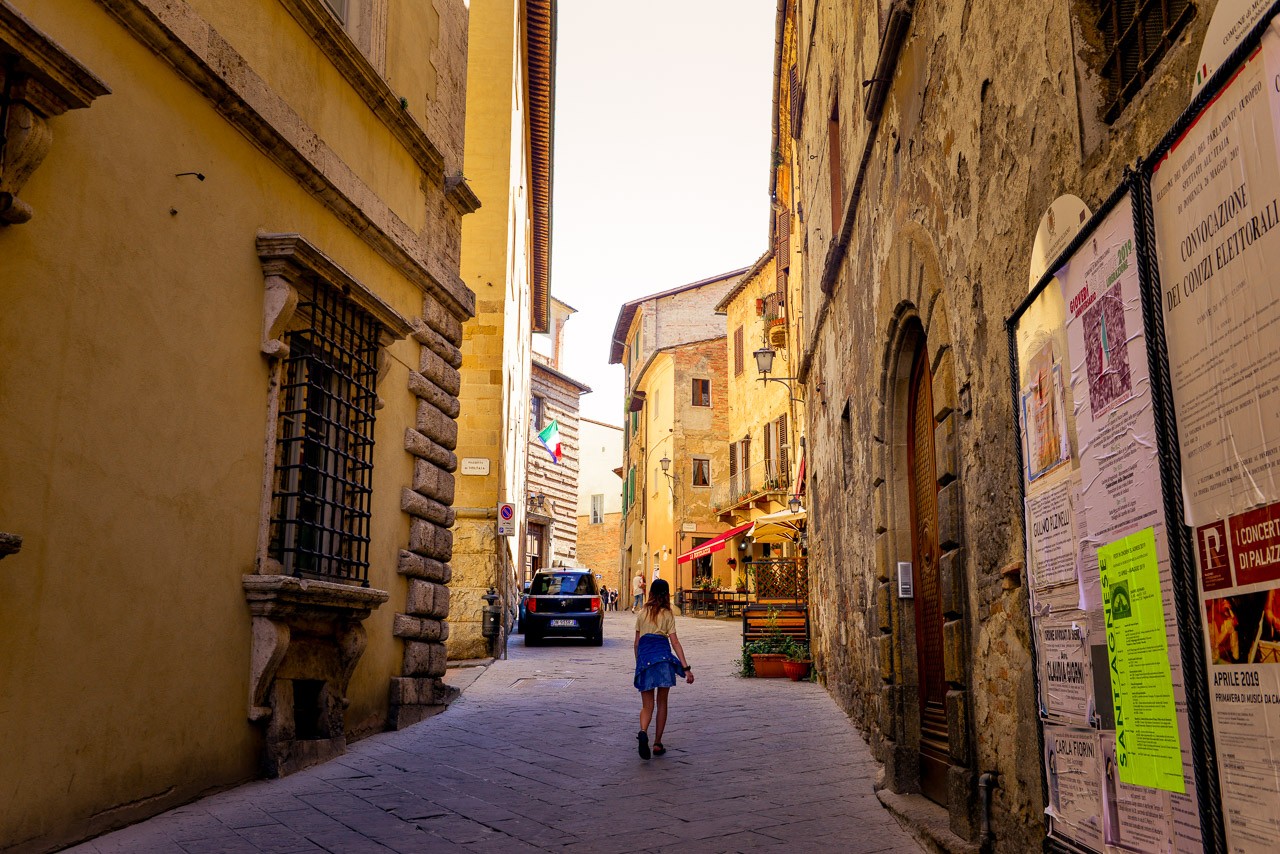 Girl walking in alley in Montepulciano