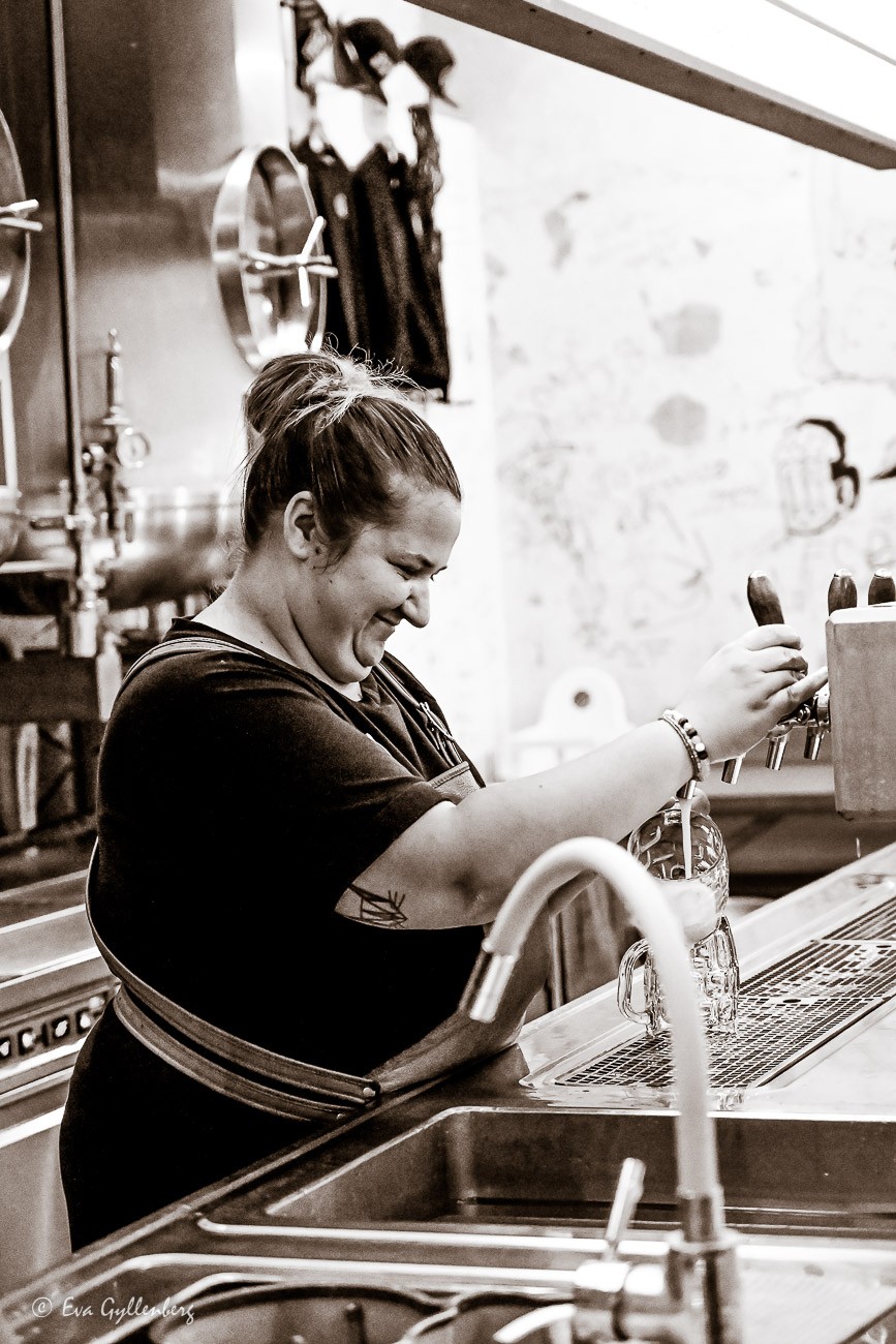 Woman pours a beer
