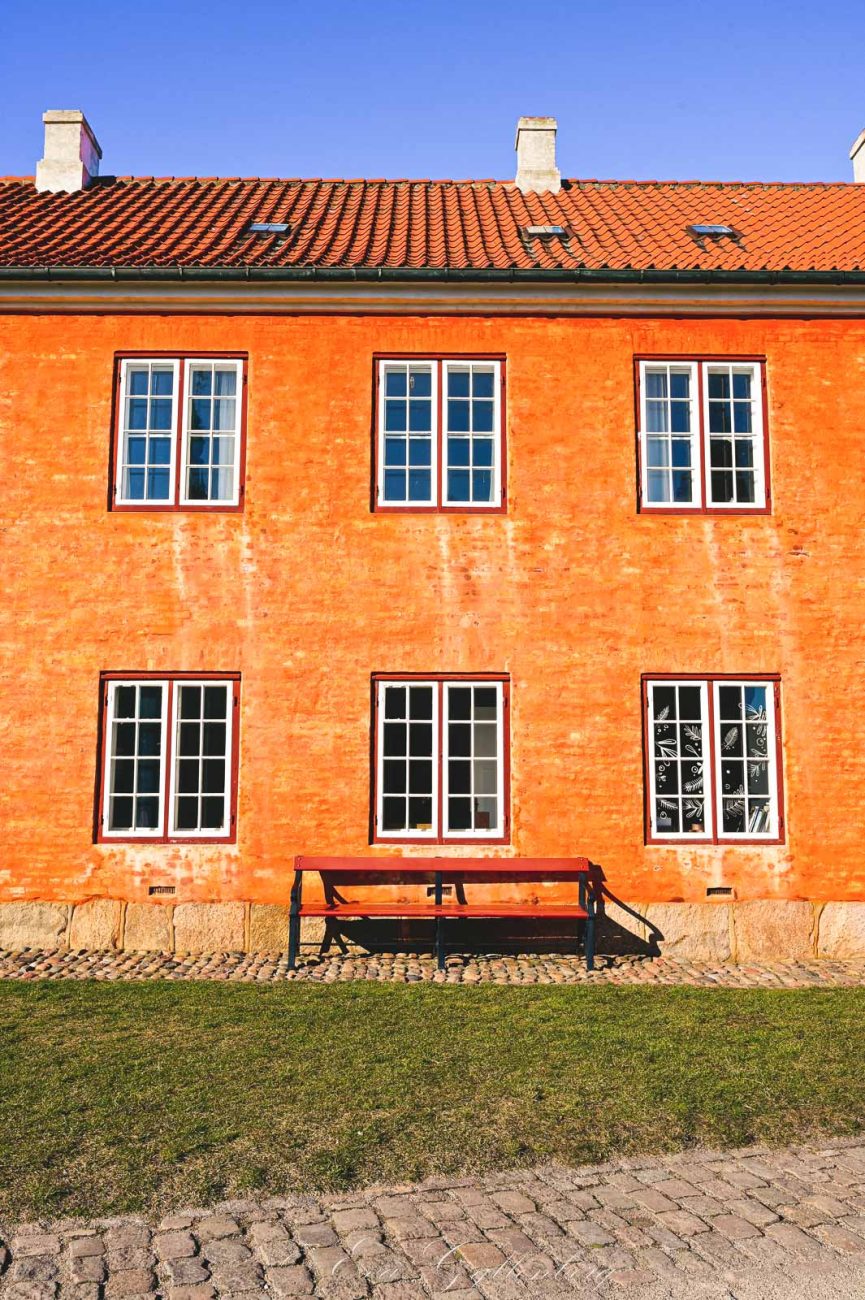 Orange house with bench in front