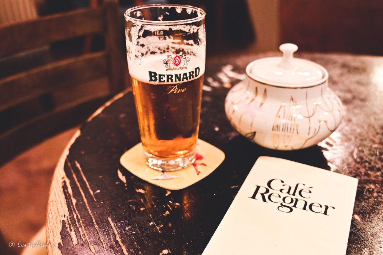 A beer, a menu and a sugar bowl on a table