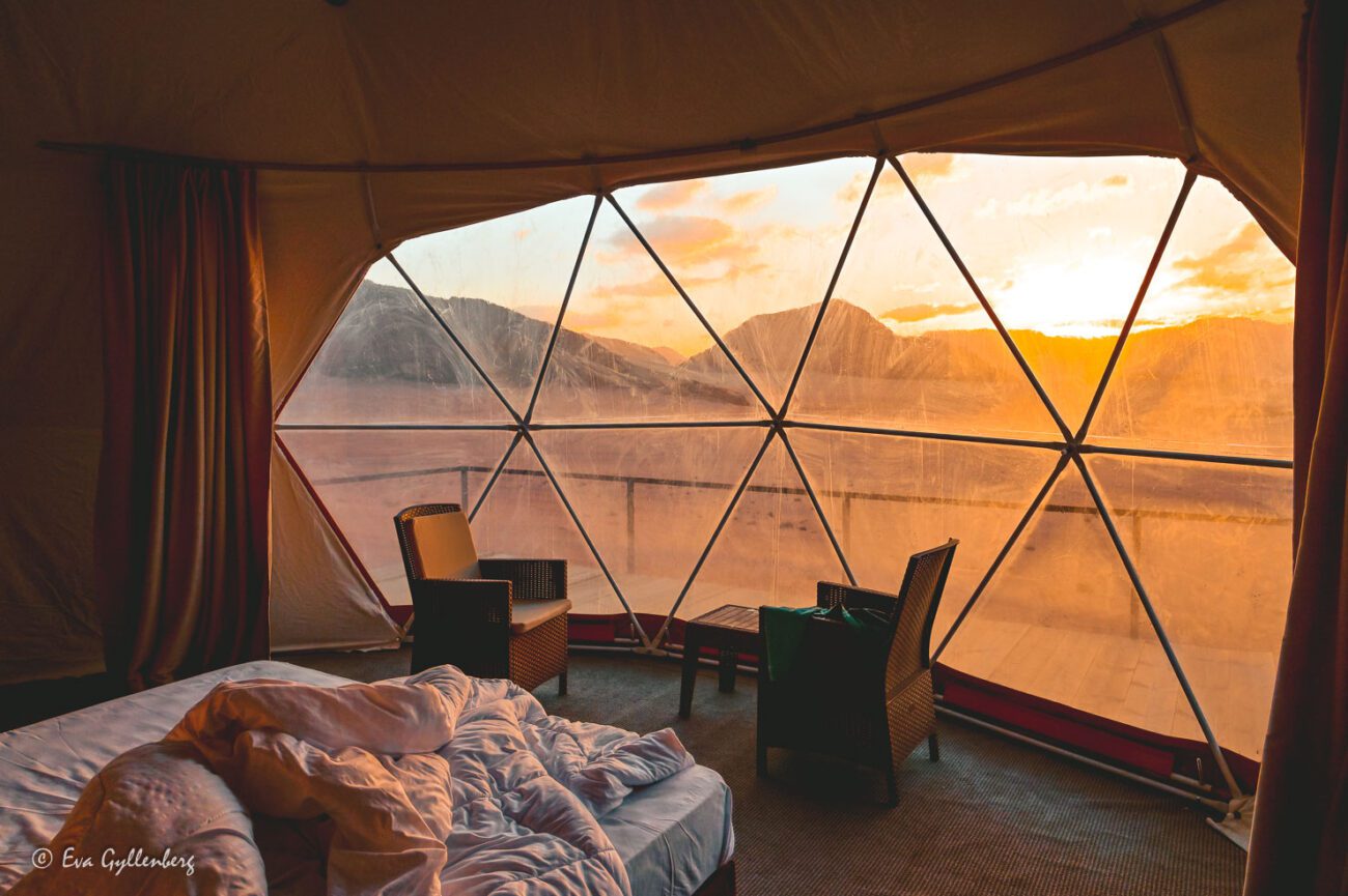 Sunrise through the window from inside a glamping igloo